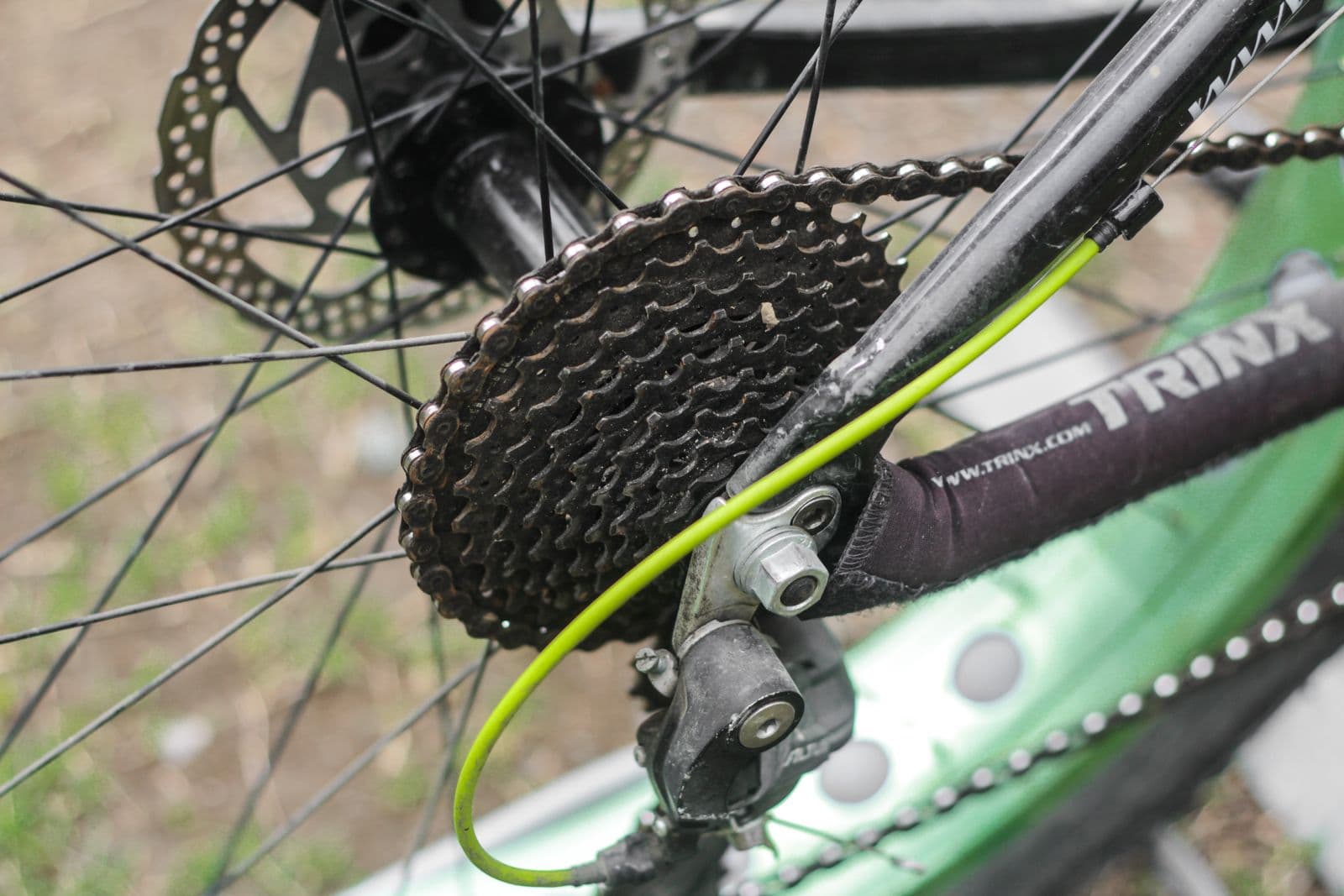 Close-up of a used cassette, chain, and rear derailleur before restoration